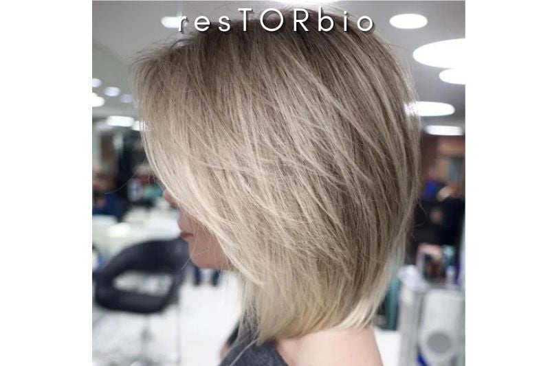 Deep Sided Blonde Bob in Face-Framing Feathers