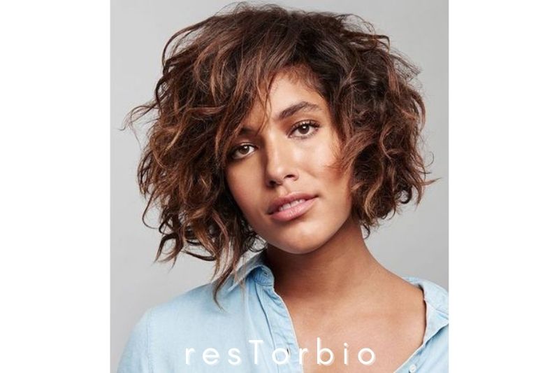 Short curly hair with side-swept bangs
